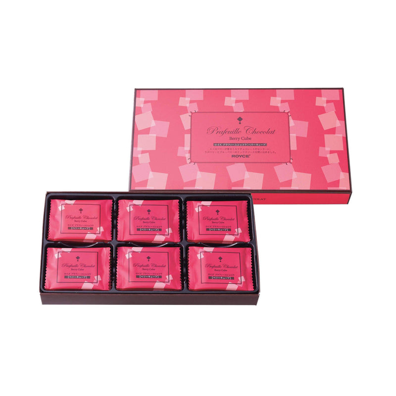 ROYCE' Chocolate - Prafeuille Chocolat Berry Cube - Image shows on top center right a pink box with cube prints. Text says Prafeuille Chocolat Berry Cube ROYCE'. Below on center left is a box with individually-wrapped chocolates with pink wrapper and cube prints. Text says Prafeuille Chocolat Berry Cube.