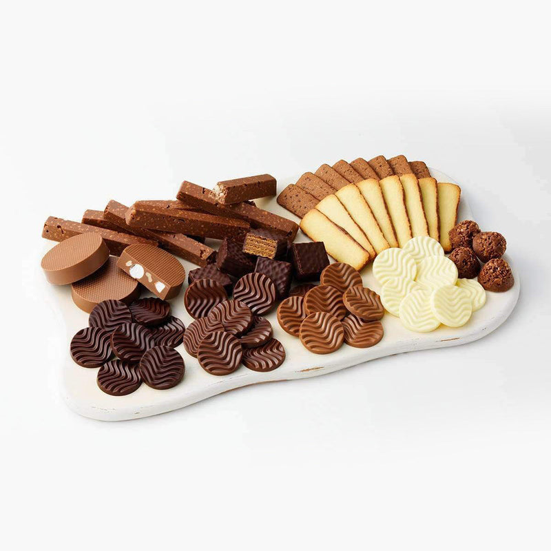 ROYCE' Chocolate - ROYCE' Collection Blue - Image shows different kinds of confections in various shapes and colors, as arranged on a white wooden tray.