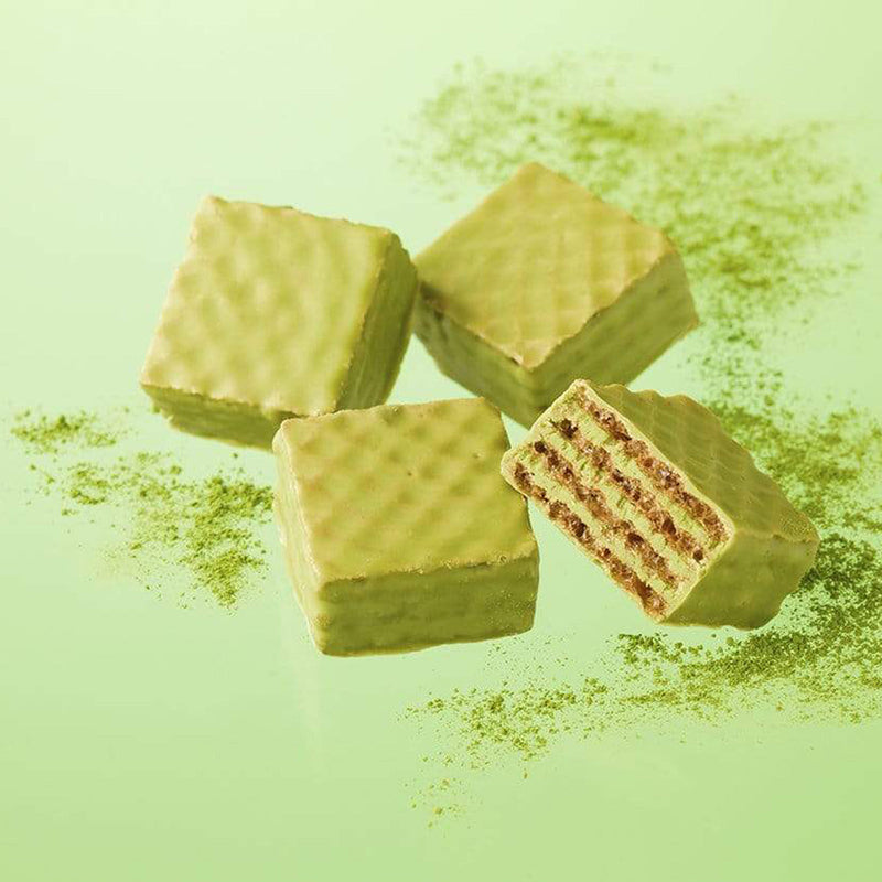 ROYCE' Chocolate - Chocolate Wafers Matcha - Image shows green chocolate wafers with a crisscross texture. Background is in green and has sprinkles of green tea powder.