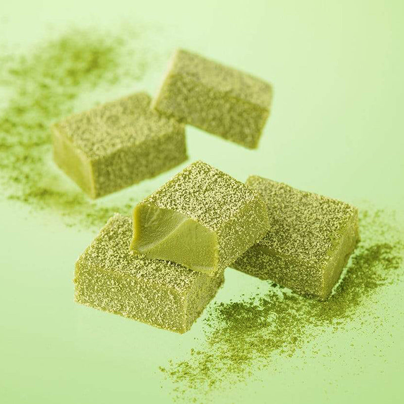 ROYCE' Chocolate - Nama Chocolate Matcha - Image shows green blocks of chocolates with green tea powder dusting. Background is green.